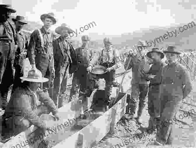 A Historical Photograph Of Miners Panning For Gold In The Yukon River During The Klondike Gold Rush, With Tents And Wooden Structures Along The Riverbank. A Land Gone Lonesome: An Inland Voyage Along The Yukon River