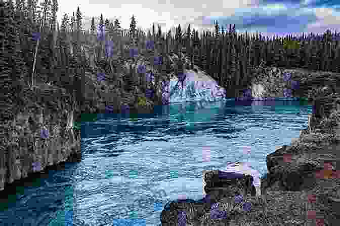 Panoramic View Of The Yukon River Flowing Through A Rugged Canyon, Surrounded By Towering Mountains And Lush Forests. A Land Gone Lonesome: An Inland Voyage Along The Yukon River